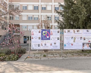 CAILUNGO, SAN MARINO - MARCH 27: The vaccination campaign poster inserted in the middle of the photos of the dead people in front of the State Hospital of Cailungo, San Marino on March 27, 2021. (Photo by Davide Bertuccio for The Washington Post)